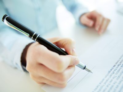 About to sign Close-up image of a business woman going to put her signature