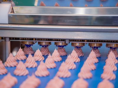 Cakes on automatic conveyor belt , process of baking in confecti Cakes on automatic conveyor belt , process of baking in confectionery factory.