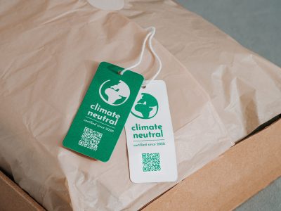 Climate neutral and carbon label concept Carbon neutral product in craft corrugated box with label Climate neutral. Carbon neutral label concept in apparel, fashion, logistics indusrty and ethical consumption. Increasing awareness for customers about carbon footpint