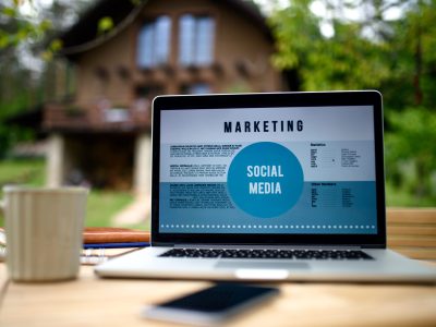 Laptop on desk outdoors in garden, home office concept. Laptop and coffee on desk outdoors in garden, home office concept.